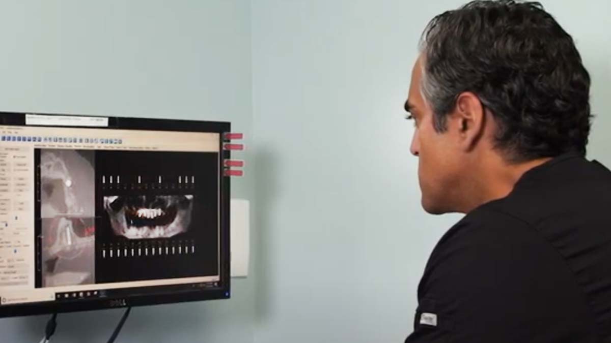 dr-snehal-patel-looking-at-computer-monitor-with-dental-implant-placement-planning-software-on-screen-3